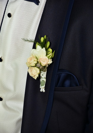 groom with flower buttonhole and black bow tieの写真素材