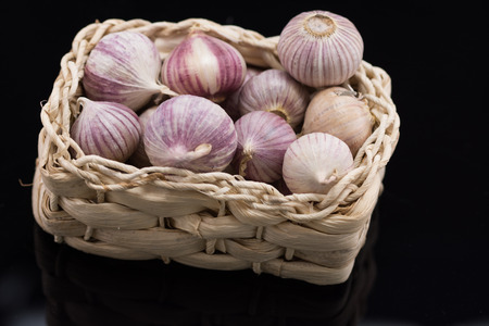Studio shot of Garlic in a wicker basket