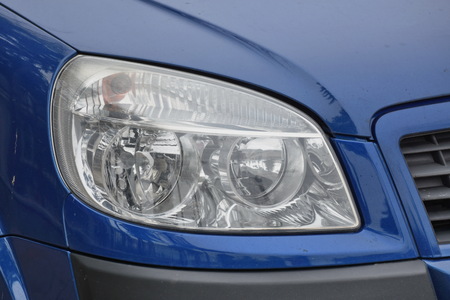 shiny headlight on a  blue car
