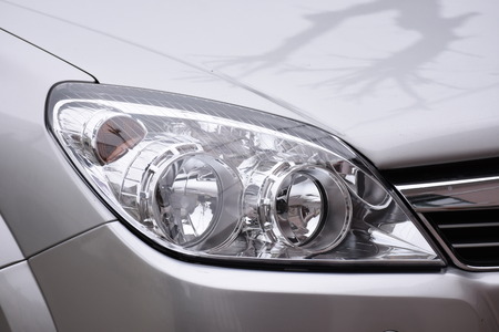 shiny headlight on a  silver car