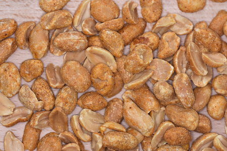 Spicy peanuts on a wooden platter