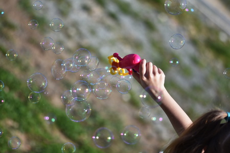 Children playing with soap bubblesの写真素材