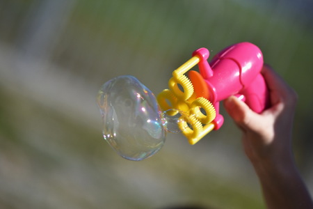 Children playing with soap bubblesの写真素材