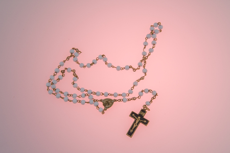 Rosary on pink backgroundの写真素材