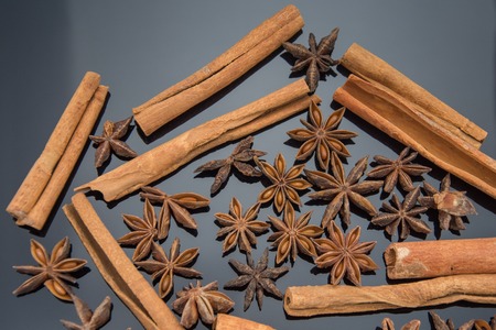 Dried anise and cinnamon on black backgroundの写真素材