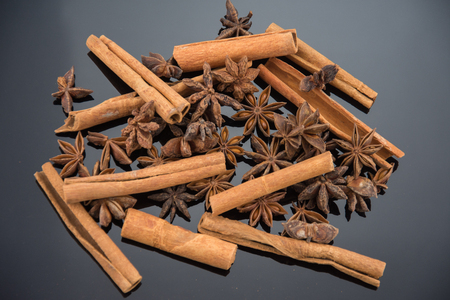 Dried anise and cinnamon on black backgroundの写真素材