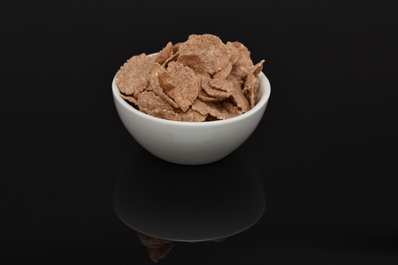 Breakfast cereal, cocoa cornflakes in a white bowl