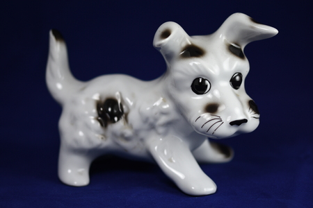 puppy, Ceramic figurine, isolated on blue   blackgroundの写真素材
