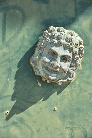 child head, sculpture on a gate in Venezia, Italy, 2019の写真素材