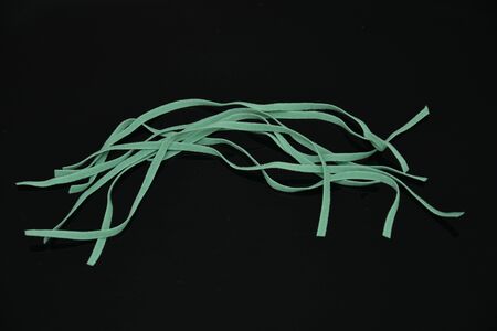 small pieces of green elastic on black , green Elastic band,detail