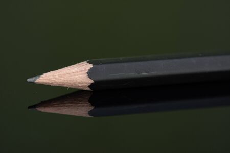 Black pencil in high resolution isolated on black background