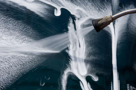 High pressure washing car outdoorsの写真素材