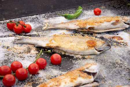 frozen fish with tomatoes and peppersの写真素材
