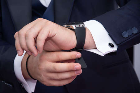 businessman, groom, showing his new watch