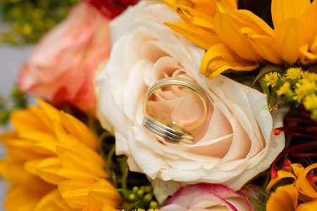Flowers with wedding gold ringsの写真素材