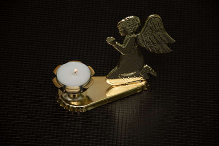 a golden angel and a candle