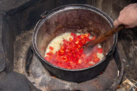 finely chopped red onion and sweet bell pepper ready for the cauldron, specialty from Romaniaの写真素材