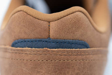 brown sneakers with fine stitching and perforated design