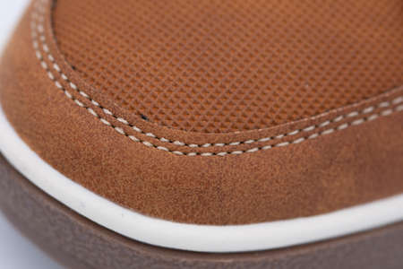 brown sneakers with fine stitching and perforated design