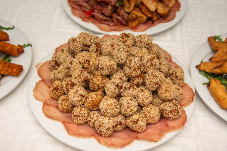 plate of meatballs with sesame seeds