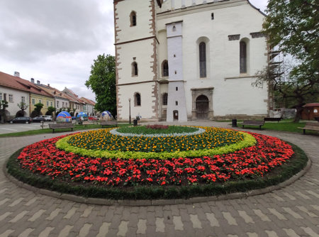 Romania, roundabout with red flowers In Bistrita  near the Evangelical Church  in Bistrita ,2020のeditorial素材