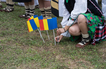 The Romanian flag next to a traditional outfit from Maramures, Romania August 2024の写真素材