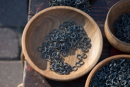 metal rings in a wooden plate used to make chains