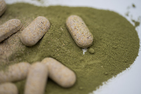 Moringa powder and organic capsules on white backgroundの写真素材