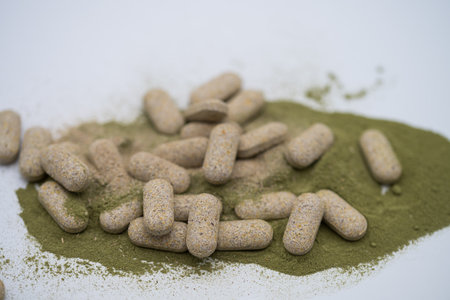Moringa powder and organic capsules on white backgroundの写真素材