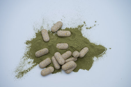 Moringa powder and organic capsules on white backgroundの写真素材