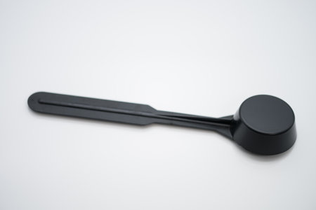 Black plastic spoon for measuring ground coffeeの写真素材