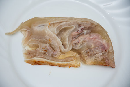 Pieces of pork prepared in Romania, Piftie, cold, drum -Sliced ââpork meat products, traditional Romanian food at winter Christmas market, Sausages and cold cuts, piftie, tobaの写真素材