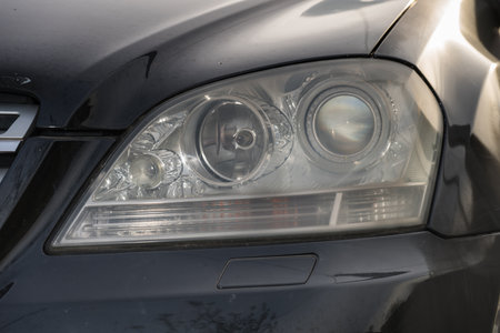 shiny headlights on a black   carの写真素材