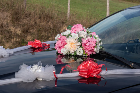 the bride and groom's car decorated with flowersの写真素材