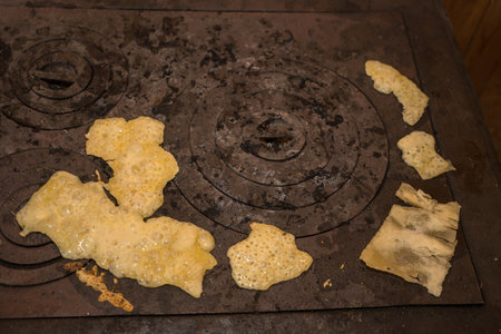 fried cheese on the stovetop of an old cast iron stove in Romania, 2025の写真素材