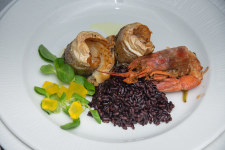 Crab with black rice, fried fish and saladの写真素材