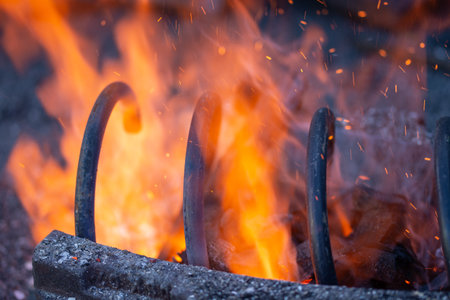 a wrought iron car arch, ,A blacksmith hardens steel at high temperature in a homemade furnaceの写真素材