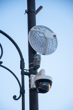 combination of a security camera and a wireless networking device mounted on a pole. The lower...
