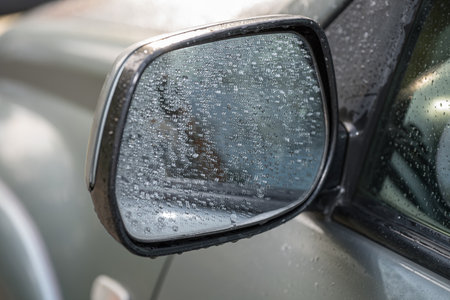 a car mirror covered in raindropsの写真素材