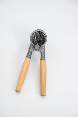 a heavy-duty nutcracker with wooden handles. It is made from enameled die-cast aluminum with quality wood handles. The design is ergonomic and comfortable to hold, making it easyの写真素材