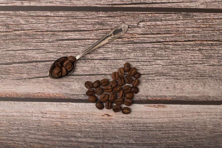 dark coffee and grains on wooden backgroundの写真素材