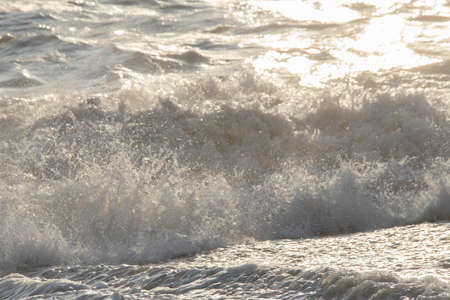 white sea foam near the shore close-up, waves