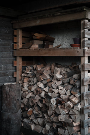 Wooden shelves filled up with firewood outdoorsの写真素材