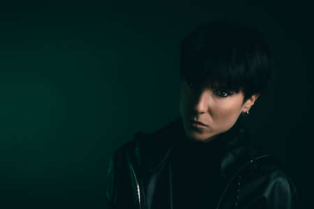 Portrait of an attractive and serious woman looking at camera in studioの写真素材