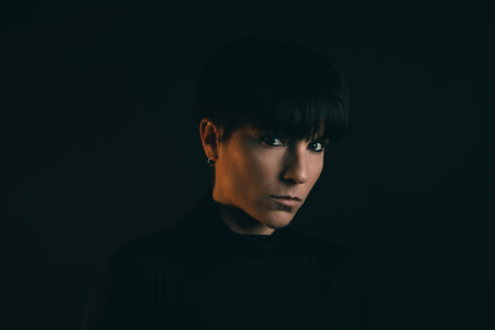 Portrait of an attractive and serious woman looking at camera in studio