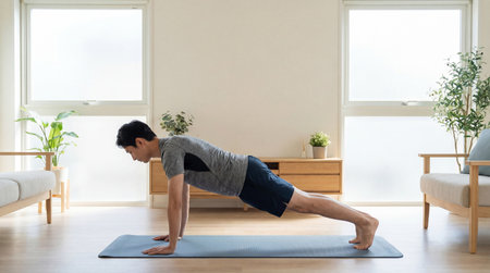Young Asian man doing yoga exercise at home. Healthy lifestyle concept.の素材