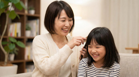 Asian Chinese little girl and her mother at home, happy family concept.の素材