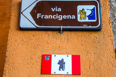 arrow sign of Via Francigena, ancient pilgrimage route through italy and franceの写真素材