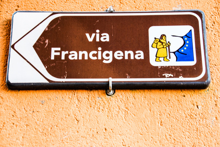 arrow sign of Via Francigena, ancient pilgrimage route through italy and franceの写真素材