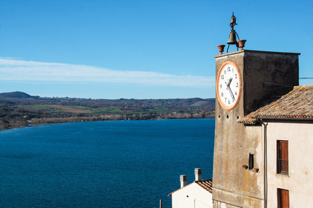 view of Bolsena lake from the fortress of Capodimonte with clock tower watching the lake , Capodimonte, Viterbo, Lazio, Italyの写真素材